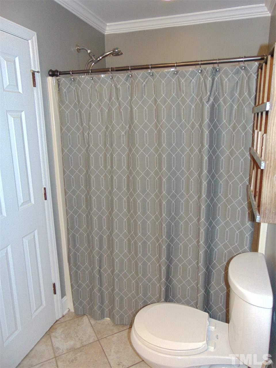 116 Crosspine Drive Raleigh, NC 27603 - Photo 16 of 21 a white toilet sitting next to a shower curtain