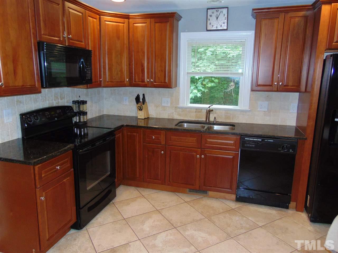 116 Crosspine Drive Raleigh, NC 27603 - Photo 8 of 21 a kitchen with stainless steel appliances granite countertop a stove a sink and a microwave