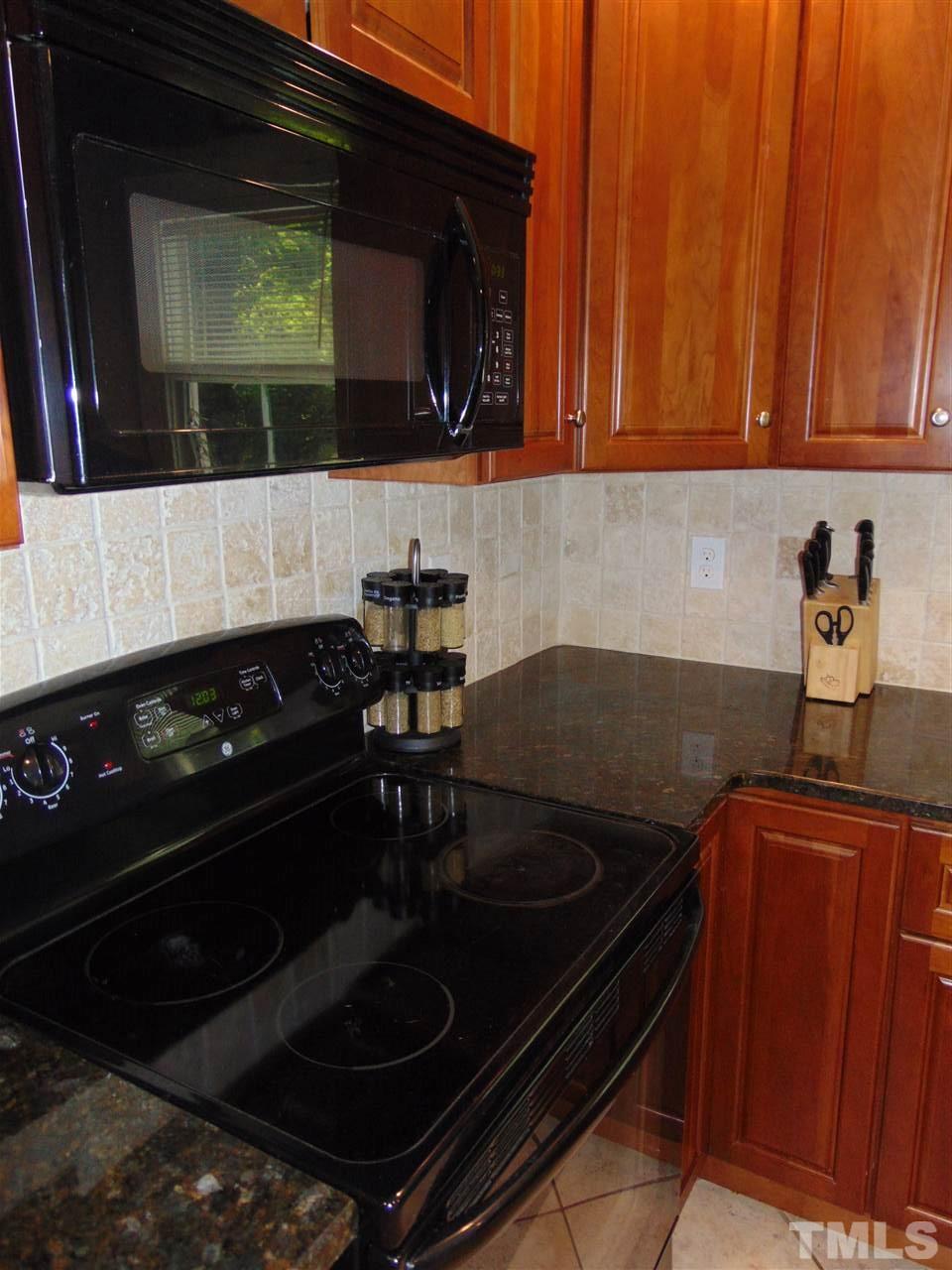 116 Crosspine Drive Raleigh, NC 27603 - Photo 9 of 21 a kitchen with a stove and a microwave