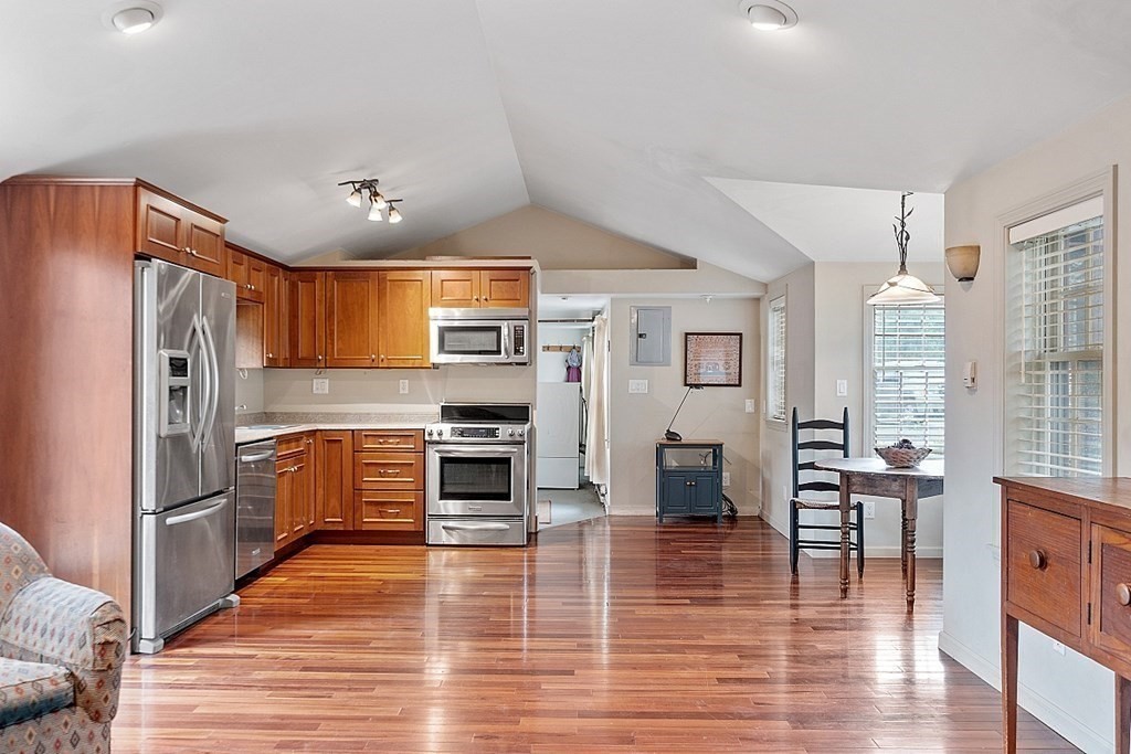 7 Groton-Shirley Road Ayer, MA 01432 - Photo 13 of 42 a kitchen with stainless steel appliances a refrigerator and wooden floor