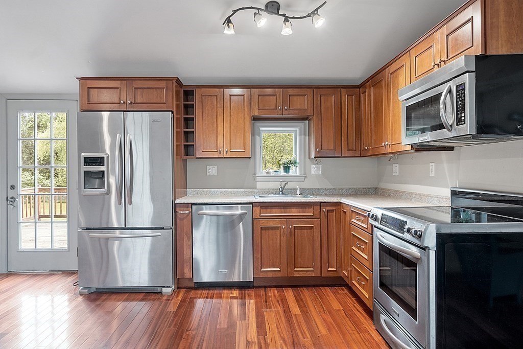 7 Groton-Shirley Road Ayer, MA 01432 - Photo 17 of 42 a kitchen with stainless steel appliances granite countertop a refrigerator microwave and sink