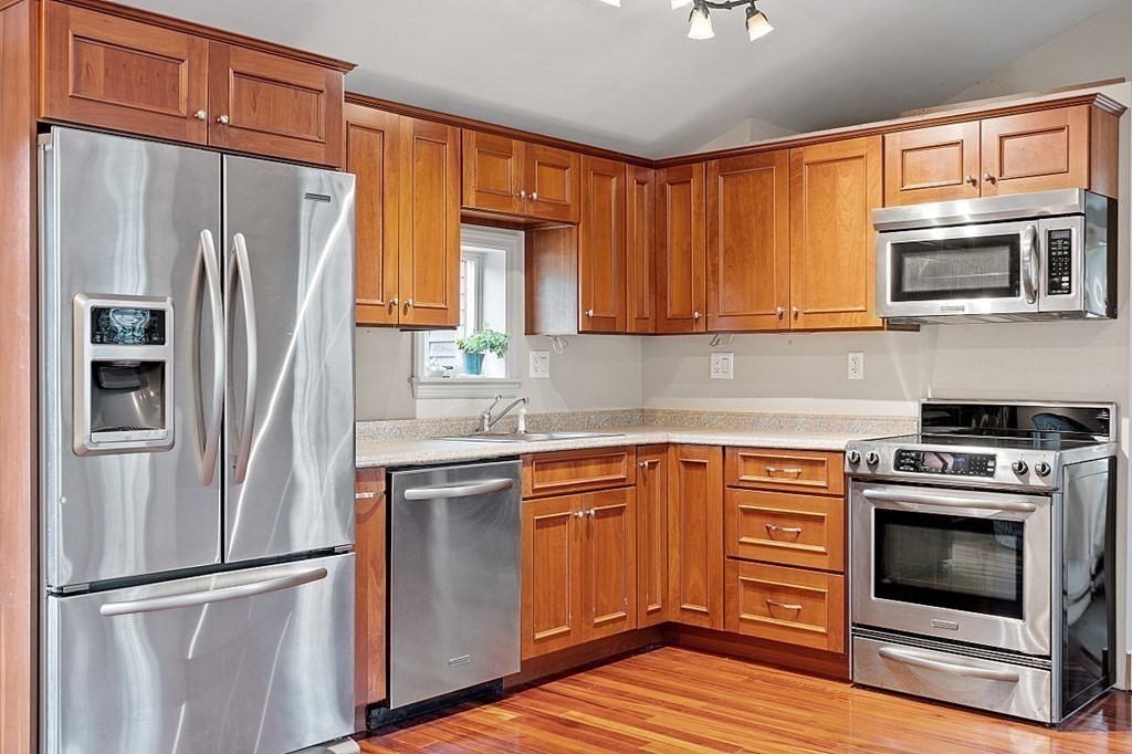 7 Groton-Shirley Road Ayer, MA 01432 - Photo 19 of 42 a kitchen with stainless steel appliances granite countertop a refrigerator stove and microwave