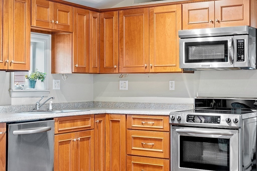 7 Groton-Shirley Road Ayer, MA 01432 - Photo 20 of 42 a kitchen with stainless steel appliances granite countertop a stove a microwave and a sink