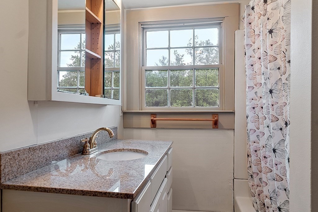7 Groton-Shirley Road Ayer, MA 01432 - Photo 25 of 42 a bathroom with a granite countertop sink a window and a granite