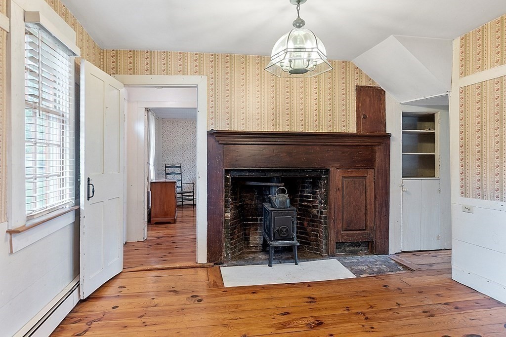 7 Groton-Shirley Road Ayer, MA 01432 - Photo 5 of 42 a view of a livingroom with wooden floor and a fireplace