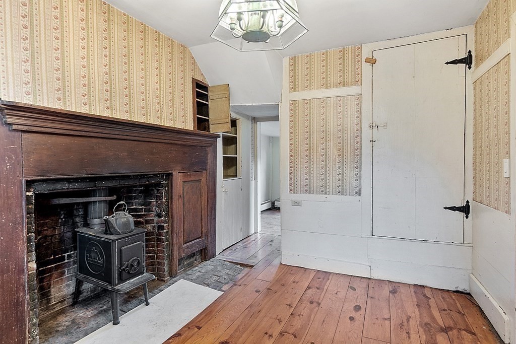 7 Groton-Shirley Road Ayer, MA 01432 - Photo 6 of 42 a view of a livingroom with wooden floor and a fireplace
