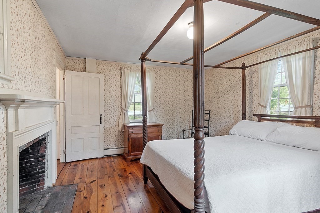7 Groton-Shirley Road Ayer, MA 01432 - Photo 8 of 42 a bedroom with a bed and a fireplace
