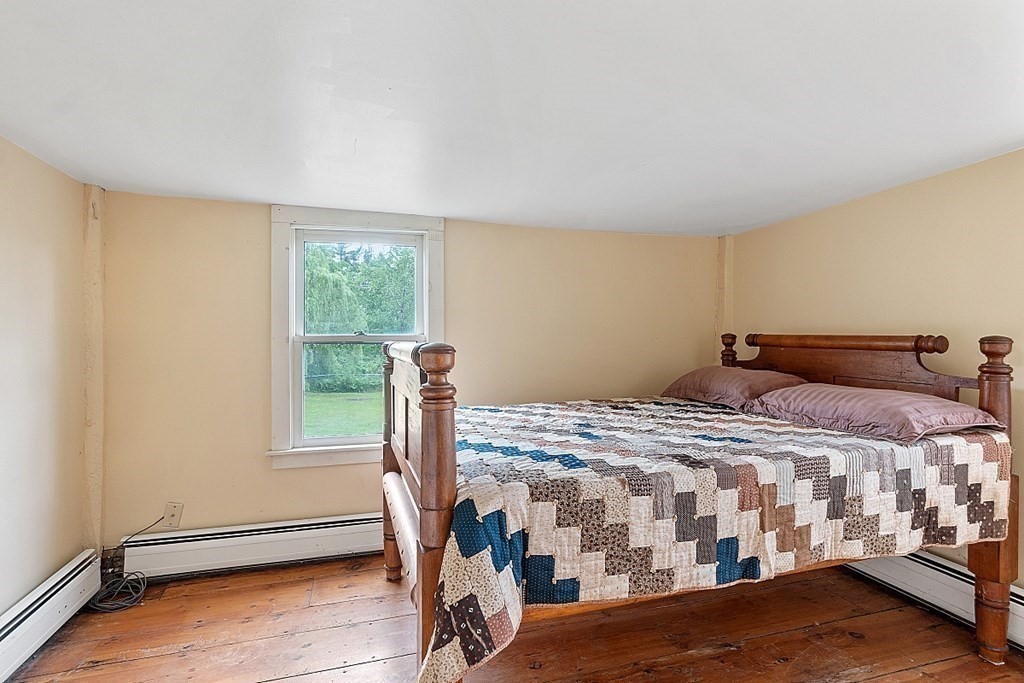 7 Groton-Shirley Road Ayer, MA 01432 - Photo 10 of 42 a bedroom with a bed and wooden floor