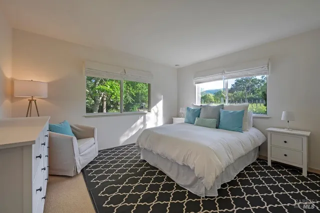 a bedroom with a large bed and a window