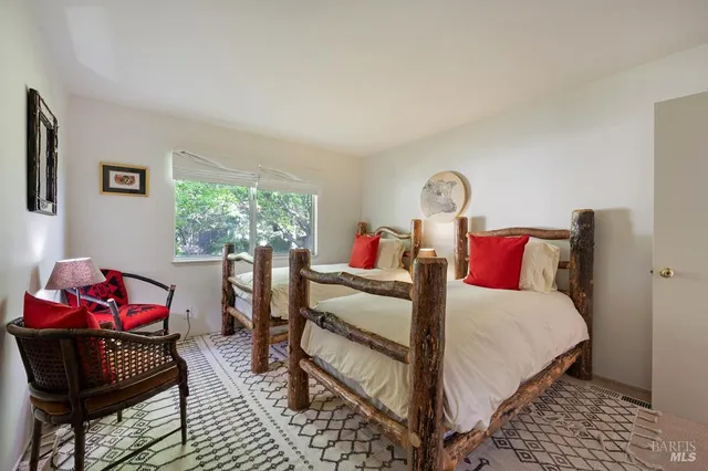 a bed room with a bed and a chair