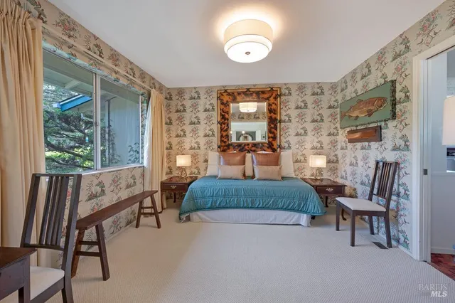 a bedroom with a bed and a chair