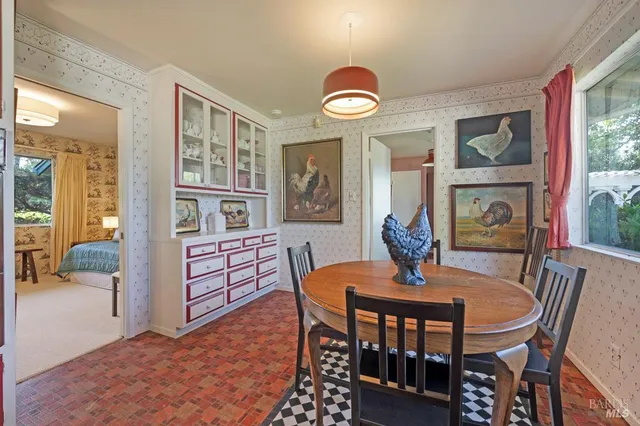 a dining room with furniture a rug and wooden floor