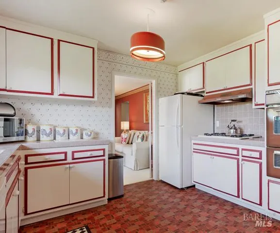 a kitchen with stainless steel appliances granite countertop a stove and a sink