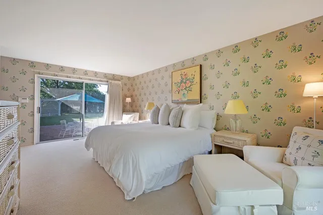 a living room with furniture and large window