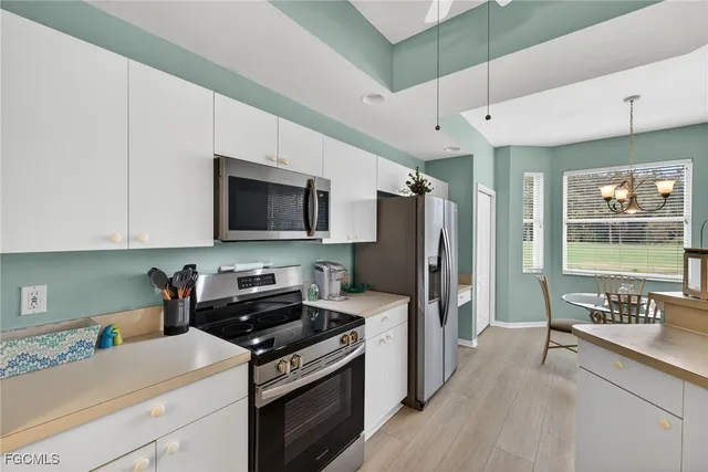 a kitchen with stainless steel appliances a stove microwave and refrigerator