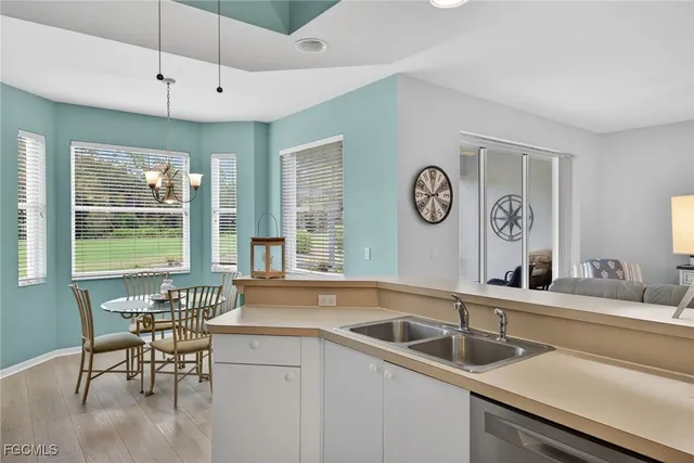 a kitchen with a sink and a clock on the table
