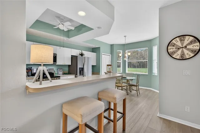 a view of a kitchen with a dining table chairs and a large window
