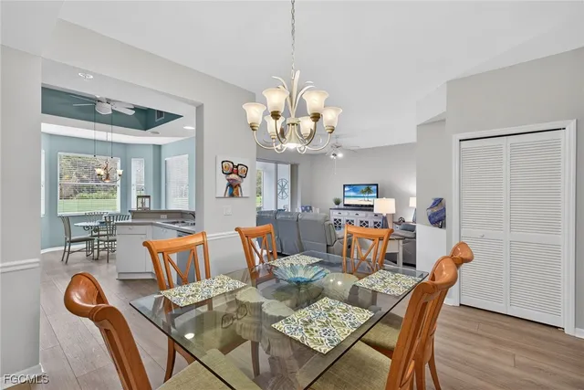a dining room with furniture a rug and a chandelier