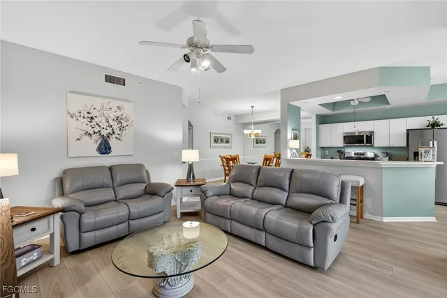 a living room with furniture kitchen view and a dining table