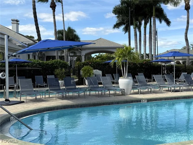a view of a house with swimming pool and sitting area