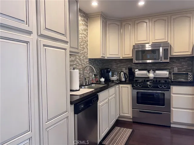 a kitchen with stainless steel appliances granite countertop a stove and a refrigerator