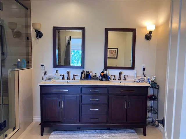a bathroom with a double vanity sink and a mirror