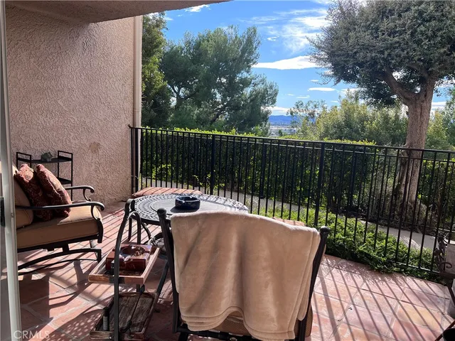 a view of a chairs and table in the balcony