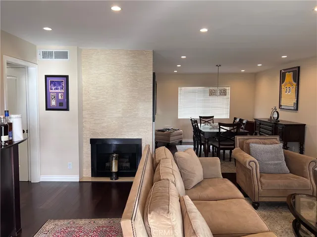 a living room with furniture wooden floor and a fireplace