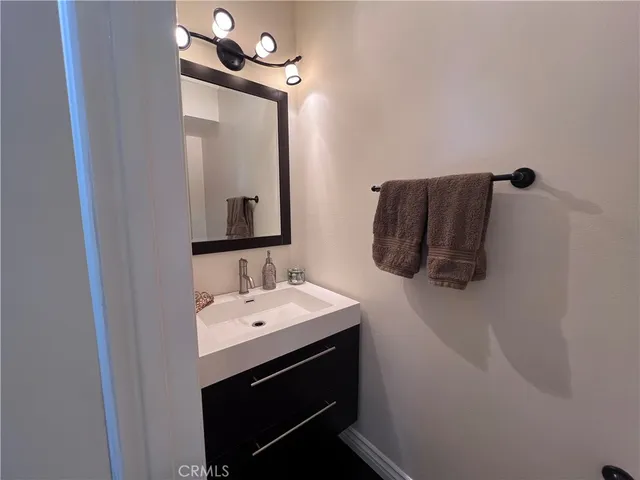 a bathroom with a sink a mirror and vanity