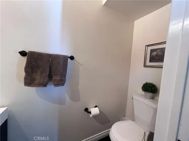 a white toilet sitting next to a small sink