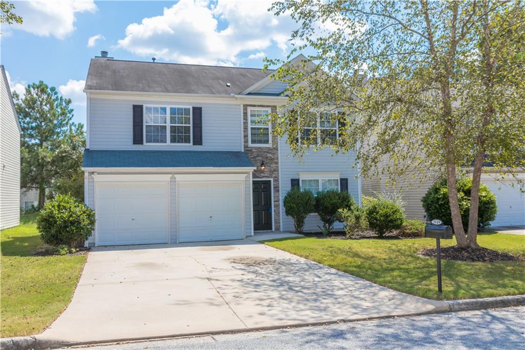 3549 Devon Chase Road Atlanta, GA 30349 - Photo 1 of 1 a front view of a house with a yard and trees