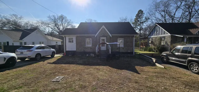 a view of a house with a yard covered in snow