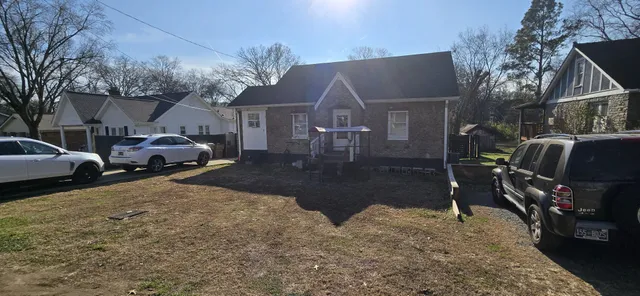 a street view with couple of cars parked on road