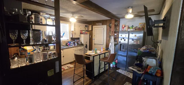 a view of a livingroom with furniture and a flat screen tv