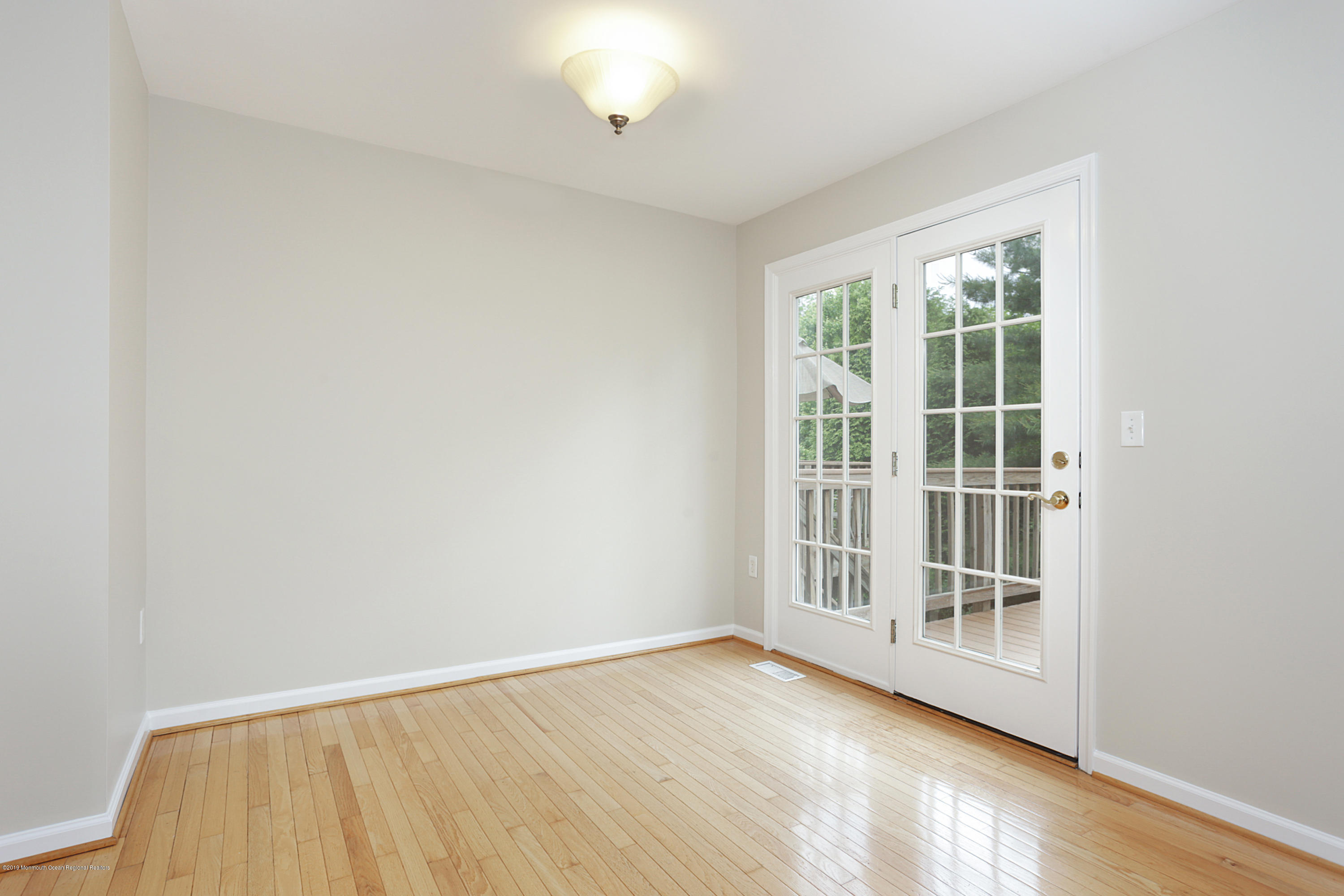 31 Abby Road Farmingdale, NJ 07727 - Photo 14 of 23 an empty room with wooden floor and windows