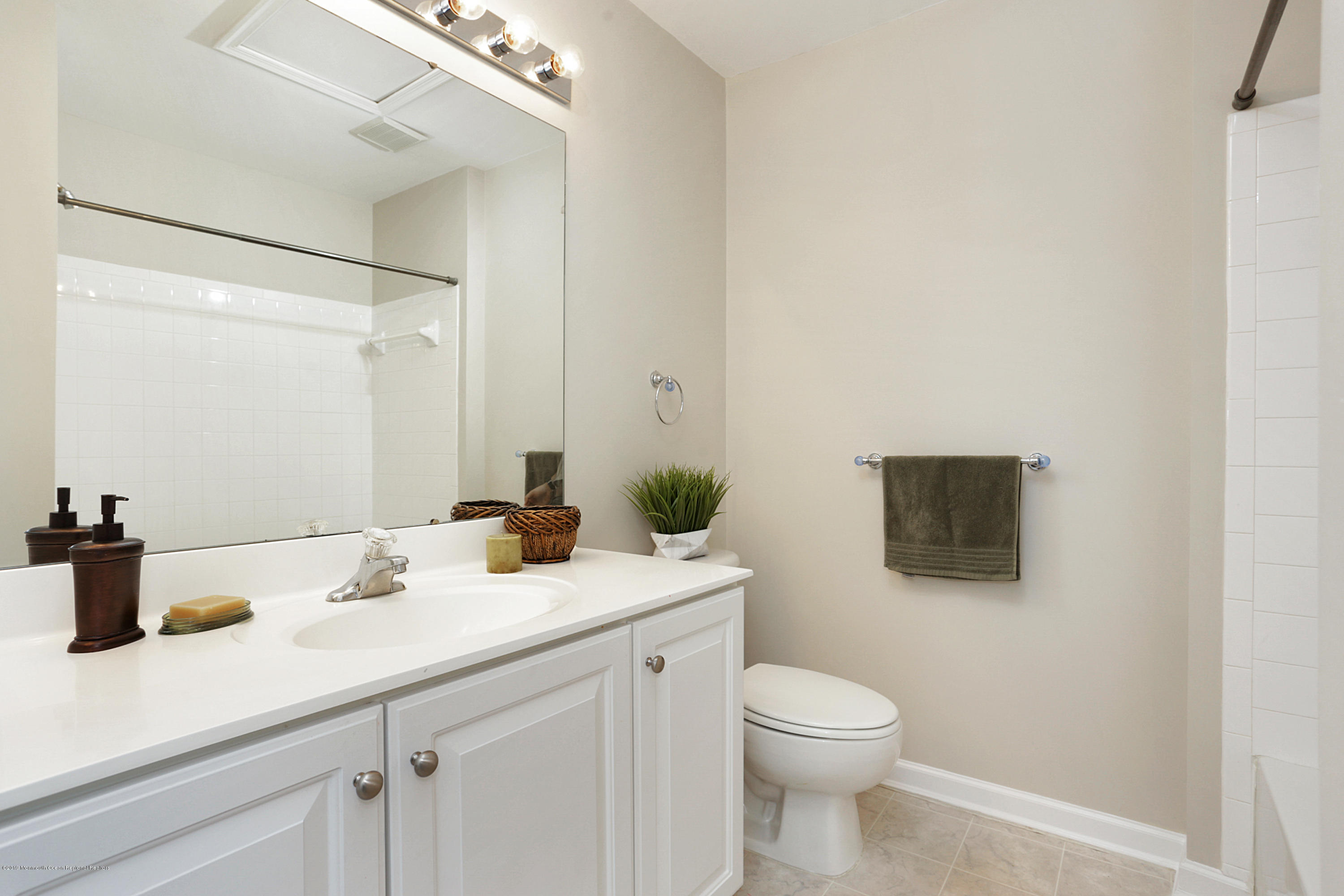 31 Abby Road Farmingdale, NJ 07727 - Photo 17 of 23 a bathroom with a toilet a sink and mirror