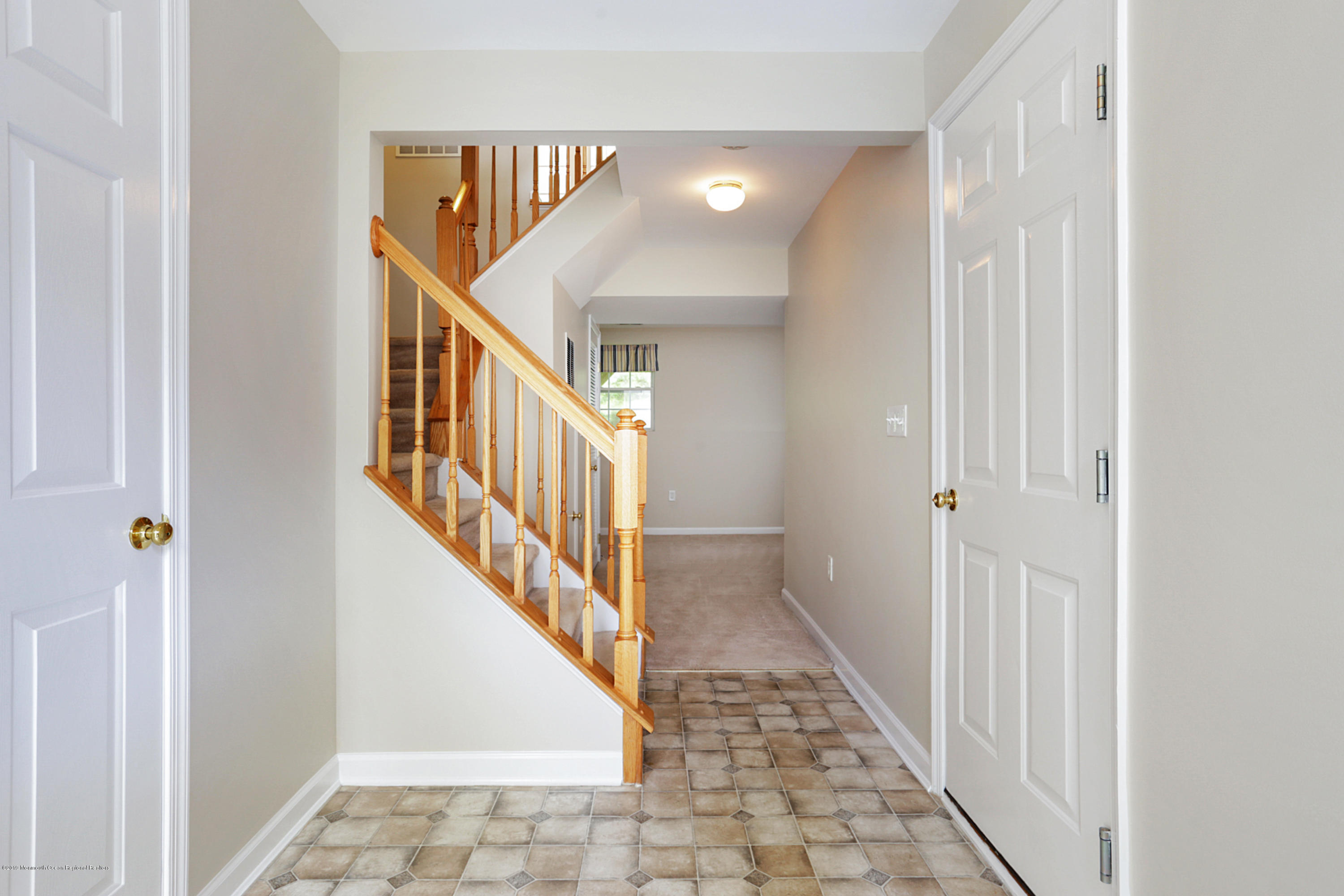 31 Abby Road Farmingdale, NJ 07727 - Photo 4 of 23 a view of a hallway with wooden floor and staircase