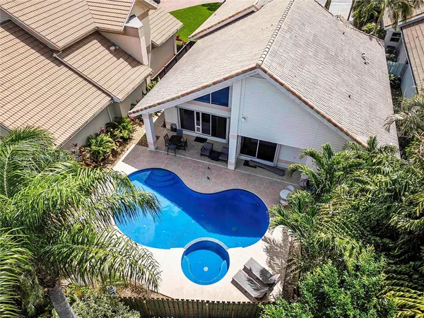 a view of swimming pool with outdoor seating and plants