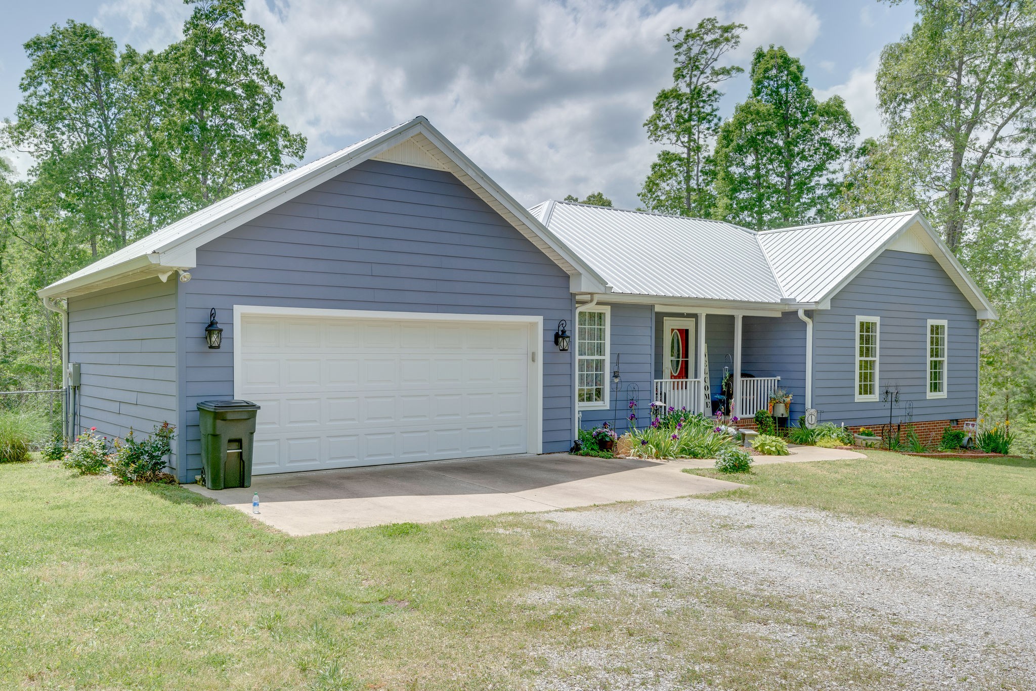 6826 Primm Springs Road Lyles, TN 37098 - Photo 2 of 28 a front view of a house with a garden and yard