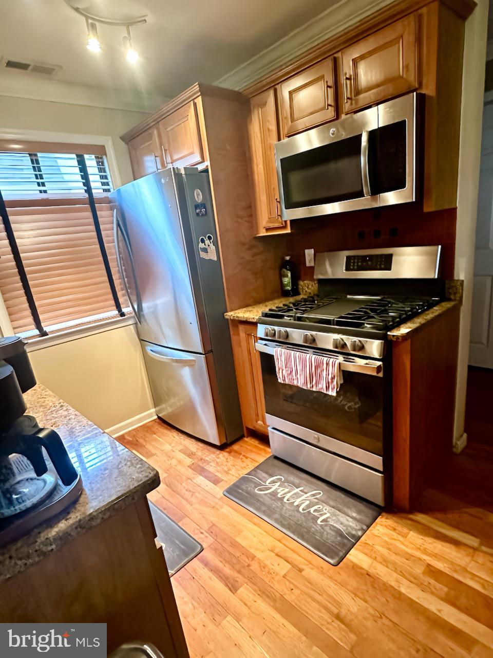 29 Gate House Lane Edison, NJ 08820 - Photo 12 of 35 a view of kitchen with stainless steel appliances cabinets and a fireplace
