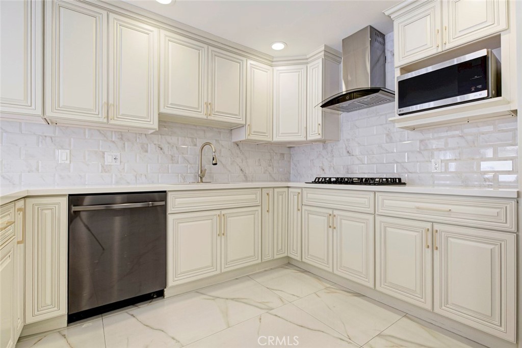 7044-1 Greeley Street Tujunga, CA 91042 - Photo 11 of 27 a kitchen with white cabinets stainless steel appliances and sink