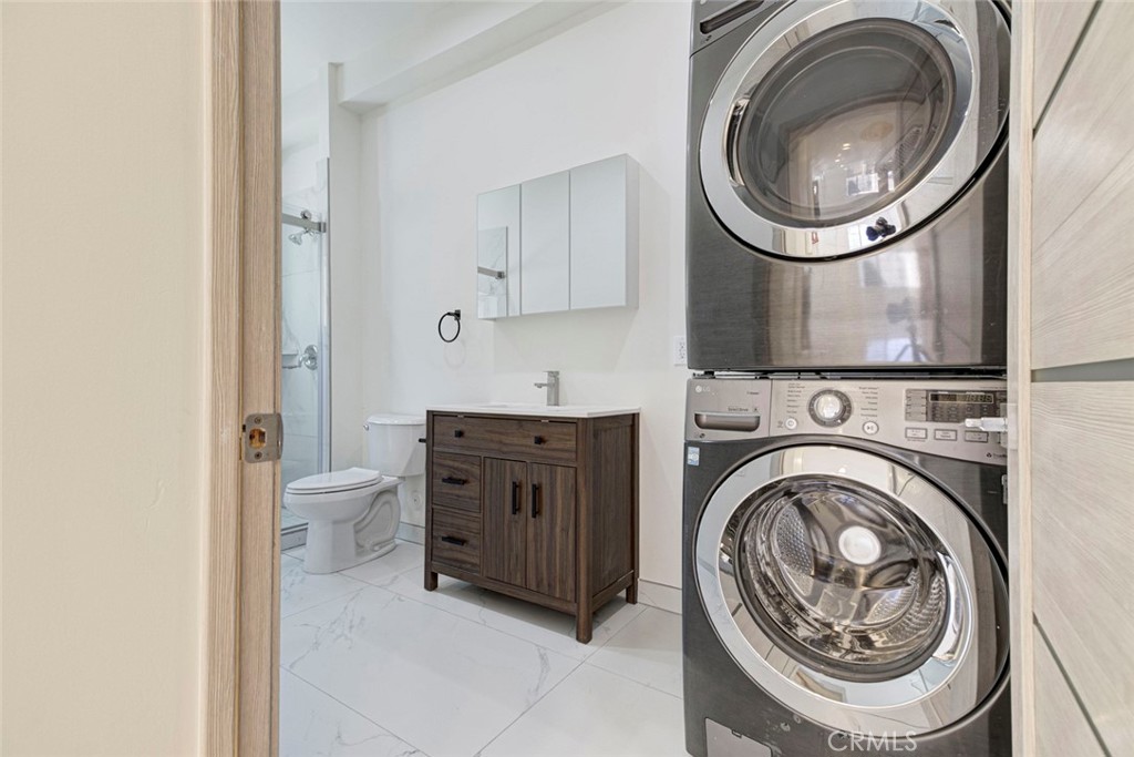 7044-1 Greeley Street Tujunga, CA 91042 - Photo 13 of 27 a view of a hallway with washer and dryer