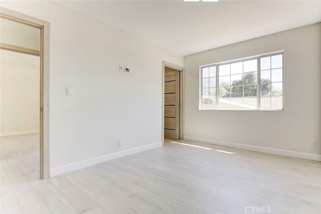 7044-1 Greeley Street Tujunga, CA 91042 - Photo 25 of 27 an empty room with wooden floor and windows