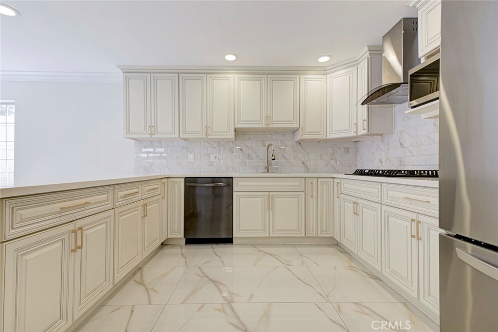 7044-1 Greeley Street Tujunga, CA 91042 - Photo 10 of 27 a kitchen with white cabinets appliances and a sink