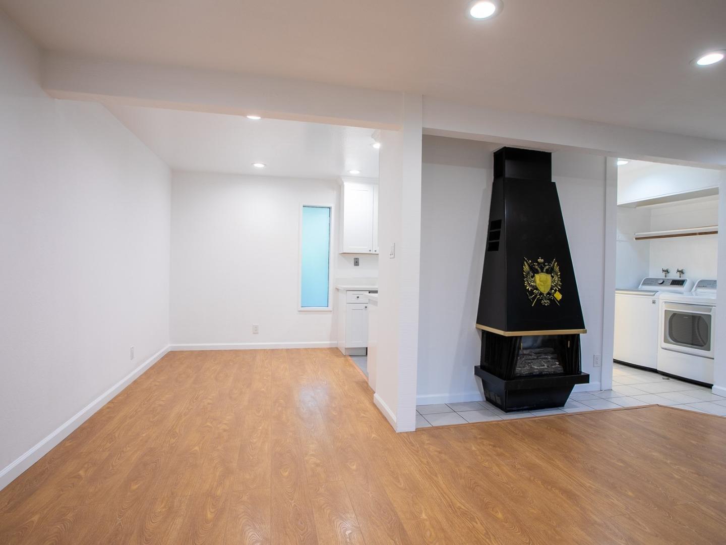 2536 West Middlefield Road Mountain View, CA 94043 - Photo 8 of 16 a view of a bedroom with wooden floor and kitchen