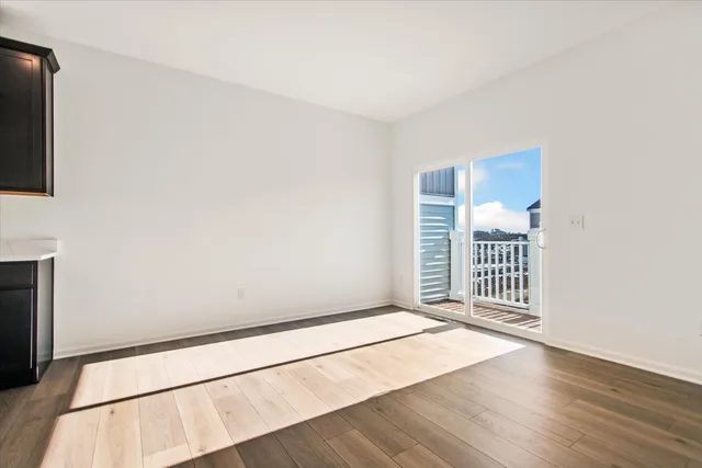 a view of a livingroom with wooden floor and a ceiling fan