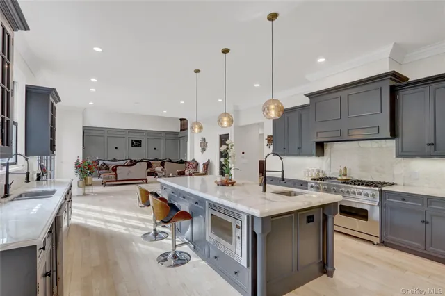a kitchen with granite countertop a sink a counter top space and living room view
