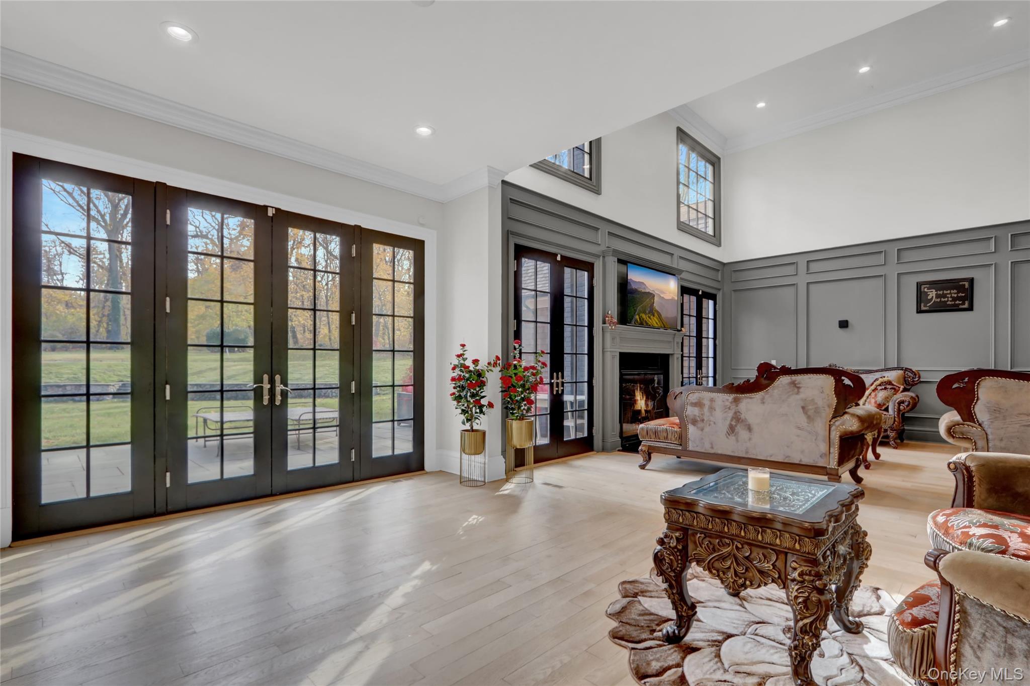 119 Wheatley Road Old Westbury, NY 11568 - Photo 13 of 45 a living room with furniture large window and a flat screen tv