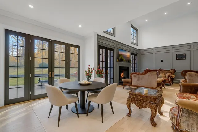 a living room with furniture large window and a fireplace