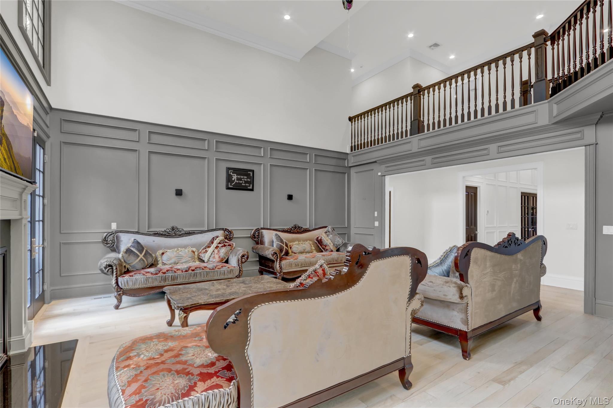 119 Wheatley Road Old Westbury, NY 11568 - Photo 15 of 45 a living room with furniture and a ceiling fan